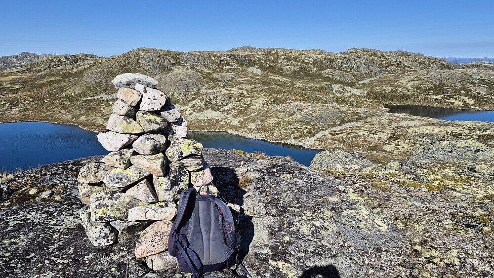 I forgrunnen er toppvarden på høyden Sørvest for Nutenuten (1340). Bakerst midt i bildet kan man skimte den svære varden på toppen av Nutenuten (1372).