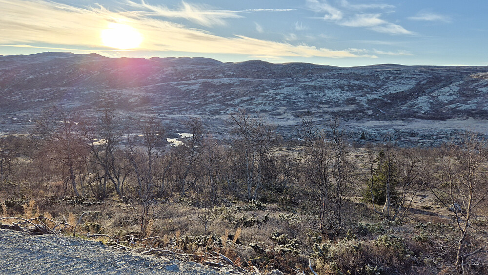 Utsikt i retning dagens turmål fra der jeg parkerte. Jeg tror ikke høyeste punkt på Staupsfjellet (1340) er synlig, men det befinner seg rett under sola. 